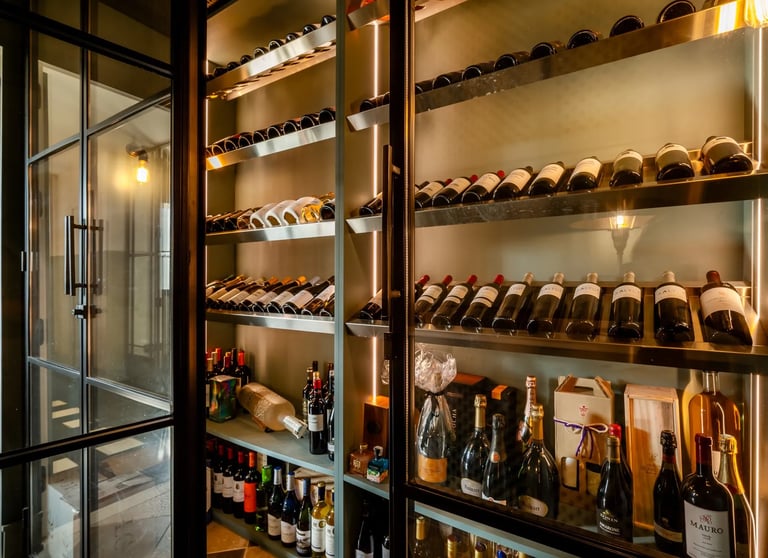 Wine cellar at Villa La Gratitud with backlit shelving and curated bottles