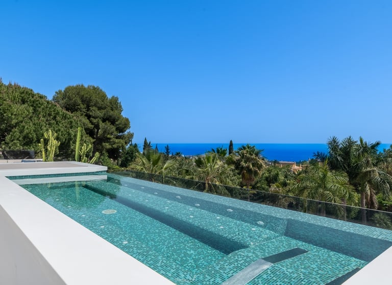 Rooftop pool, jacuzzi, and lounge area with panoramic sea views at Villa Serenity