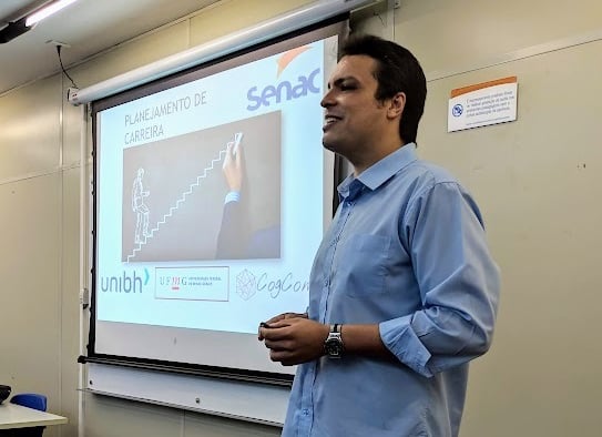 a man standing in front of a presentation screen