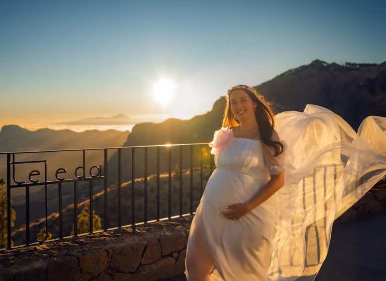 a pregnant woman in a white dress with a veil