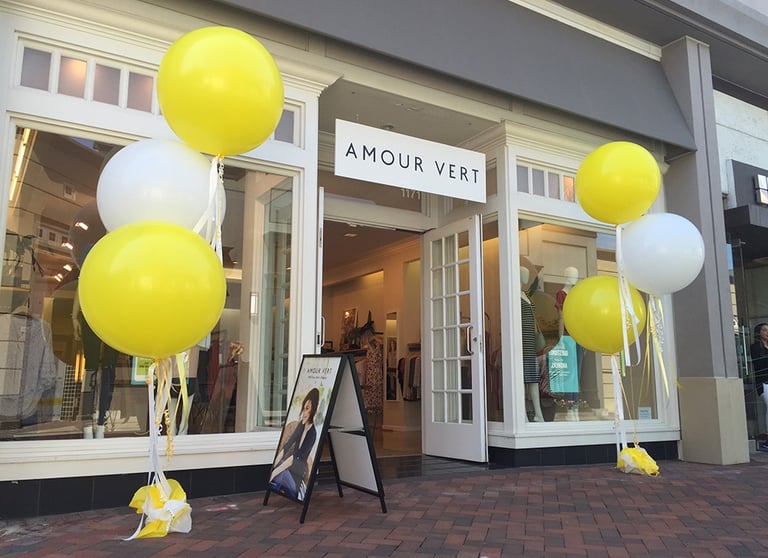 a storefront door with balloons and balloons