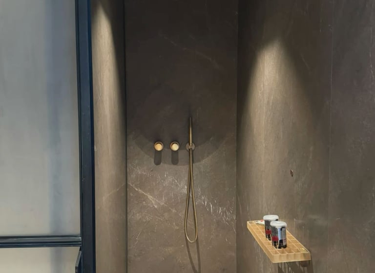 A modern and luxurious bathroom featuring multi-coloured microcement