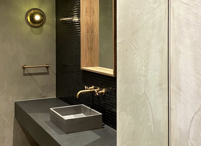 A modern and luxurious bathroom featuring multi-coloured microcement