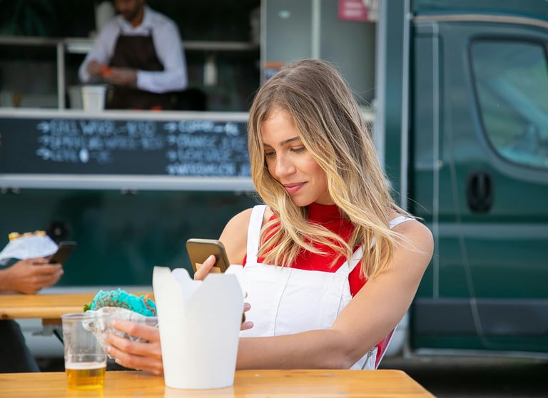 delicious food from foodtruck during lunch time eating a meal on-the-go while chatting