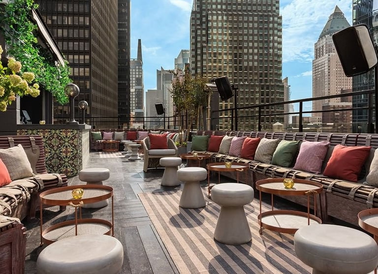 Glamorous rooftop setting at PHD Terrace with plush seating and city views, Midtown Manhattan.