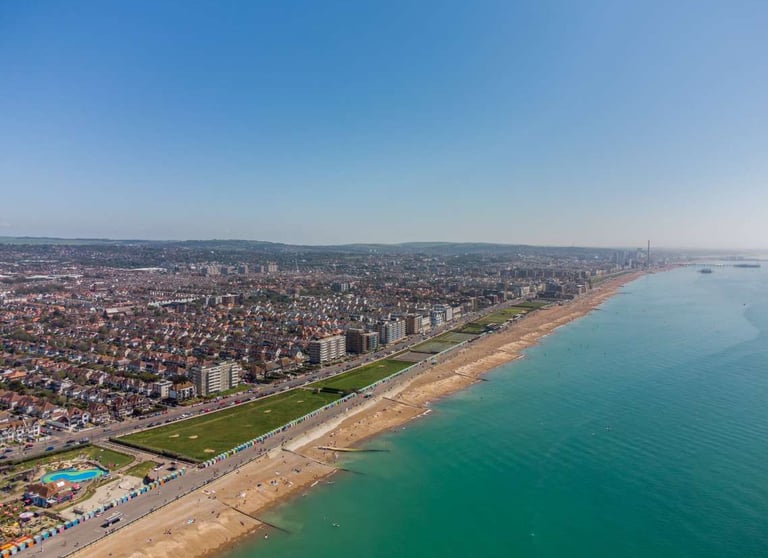 a beach with a view of the ocean and a city