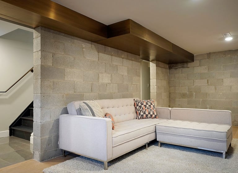 Home interior brass air vent above a couch, made by Pengelly Iron Works