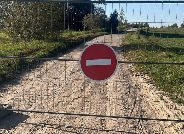 a closed gate which indicates a closed gravel road section for a private pre event rally tests (PET)