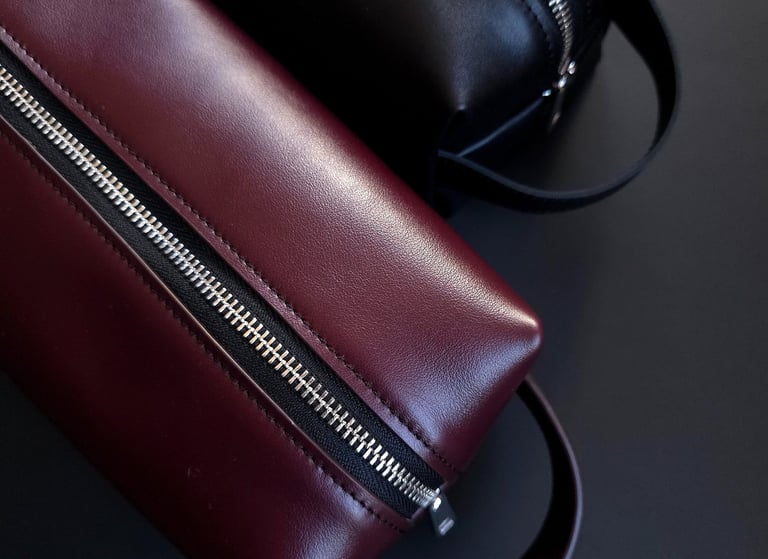Burgundy and black leather toiletry bags 