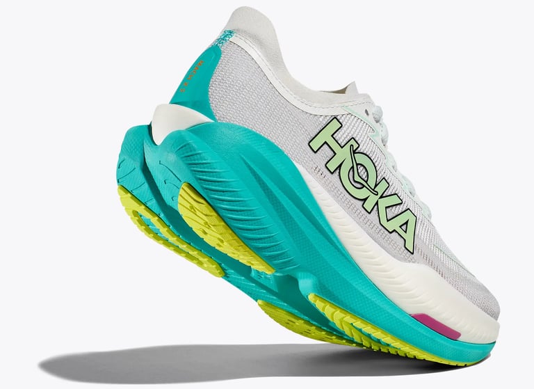 Hoka Mach X 2 running shoe in Frost/Electric Aqua colorway outdoors, showing lightweight upper and rocker profile.