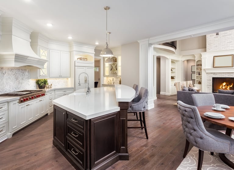 Newly built kitchen featuring custom cabinetry, countertops, flooring, and lighting