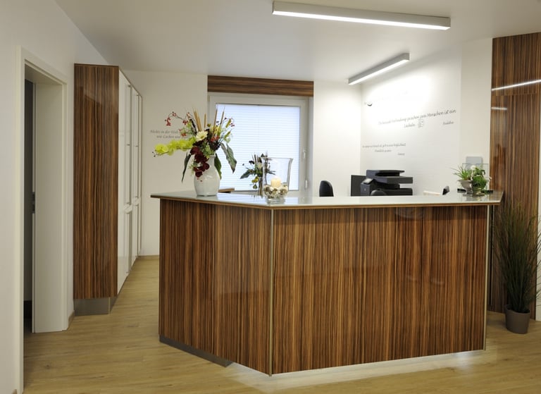 a reception table with a vase of flowers