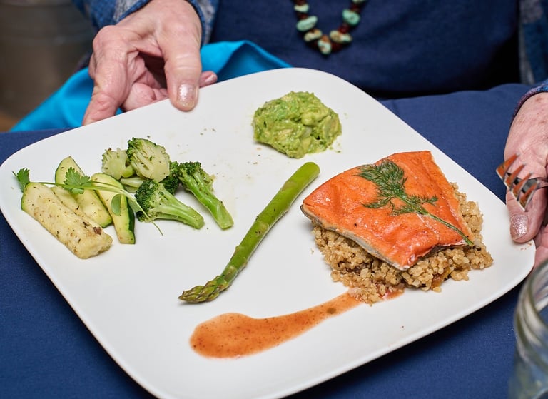 Tender Sous Vide Wild Salmon with Spiced Steamed Vegetables, Avocado Relish, and Quinoa Pilaf. 