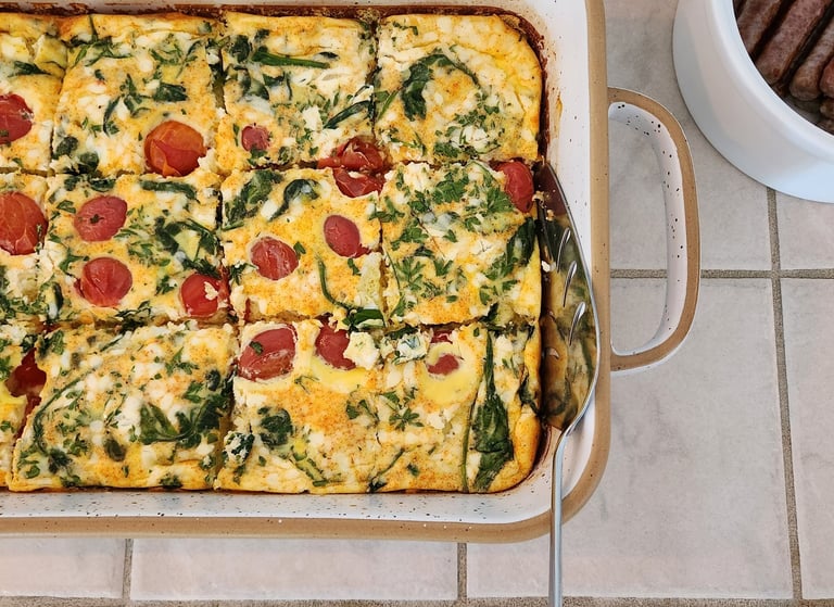 Two South Cliff Inn dishes, a vegetarian egg bake, with breakfast sausage on the side