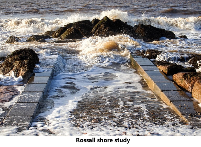 a rocky shore with waves crashing over rocks at rossall fleetwood