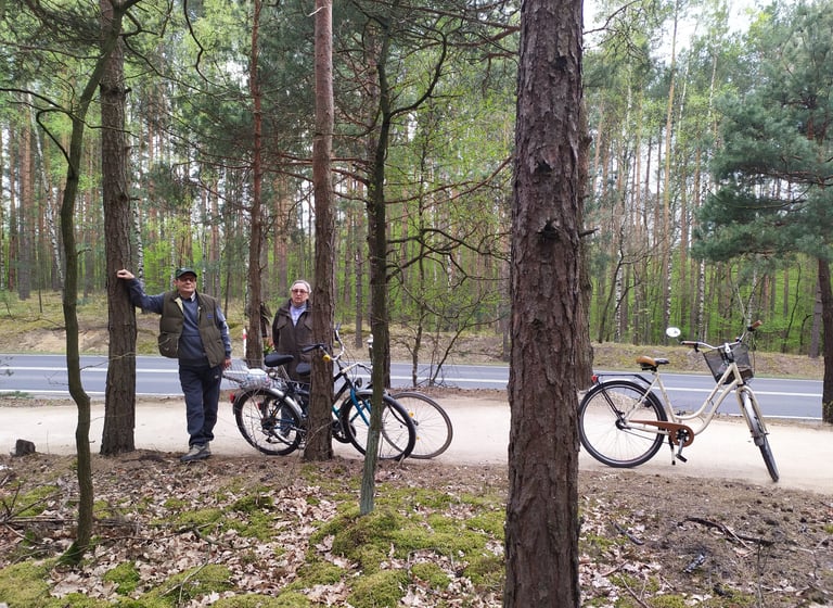 A couple standing next to each with bicycles