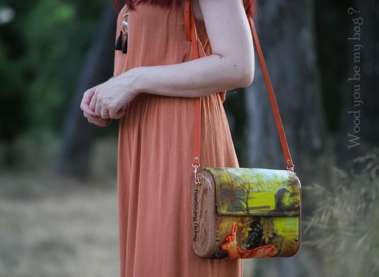a woman holding mahogany wooden bag with Bambi image