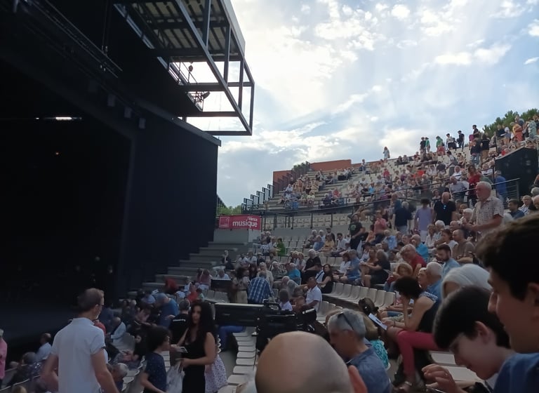 The audience gathers as night falls
