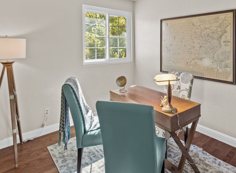 a desk with a lamp on a table