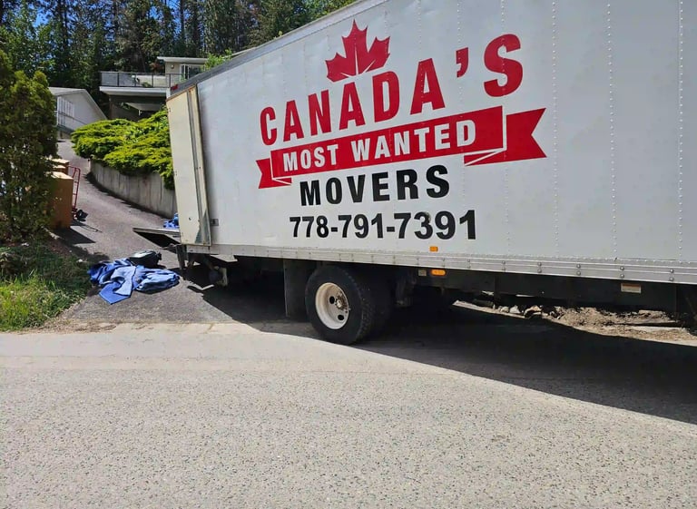 Canada’s Most Wanted Movers truck positioned on a steep driveway during a residential move in Burnaby.