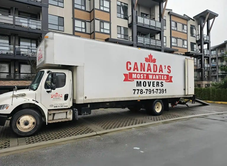 Canada’s Most Wanted Movers truck parked outside a condo complex in Langley for an apartment move.