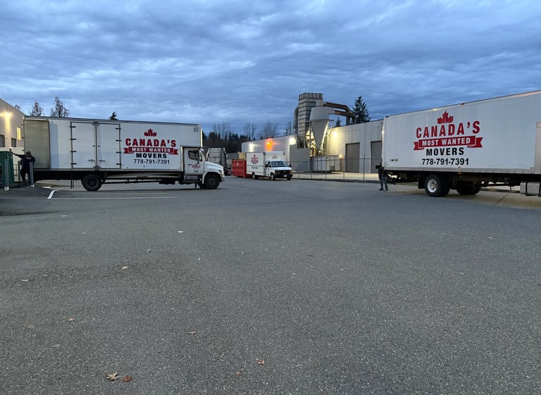 Canada’s Most Wanted Movers trucks parked at an industrial warehouse in Vancouver before a scheduled move.