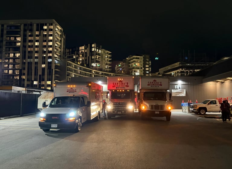 Canada’s Most Wanted Movers trucks lined up for a nighttime move in Vancouver’s residential district.
