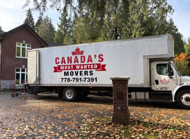 Canada’s Most Wanted Movers truck parked at a forest-side home in the Lower Mainland during a residential move.