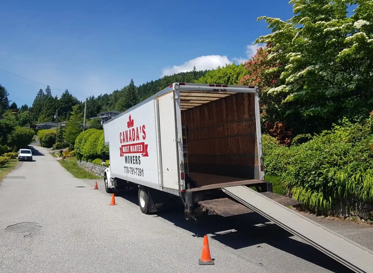 Canada’s Most Wanted Movers truck unloading at a quiet residential street on Vancouver Island.