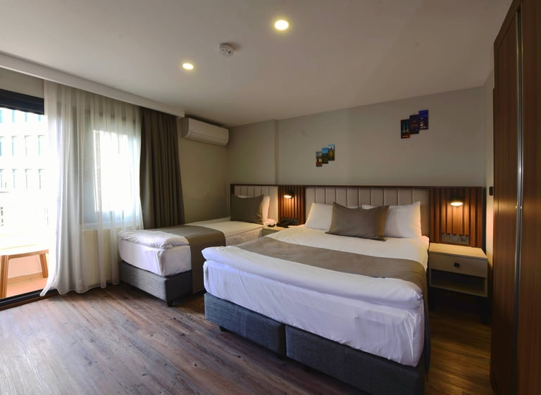 a hotel room with two beds and a balcony