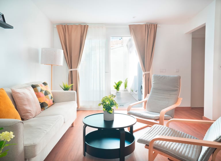 a living room with a couch and chairs