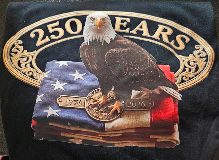 A patriotic 250 years anniversary t-shirt featuring an American bald eagle perched on a folded flag.