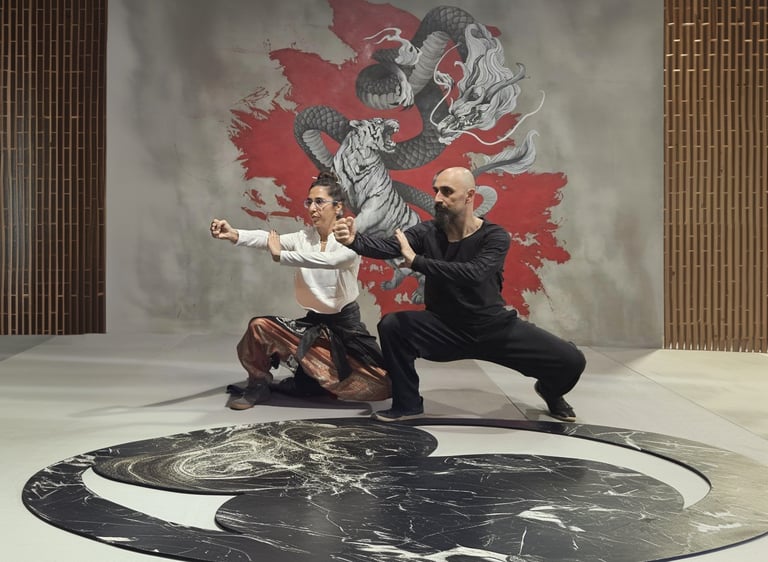 Ismet Himmet and Gizem Kara practicing a Tai Ji form on a yin-yang mat before a dragon mural.