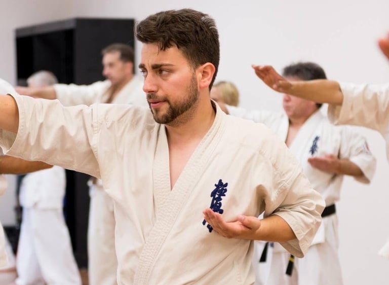 a man in a karate uniform is doing karate moves
