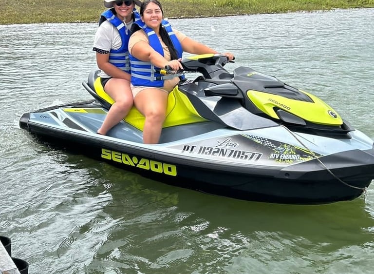 a woman and a man riding a jet skis