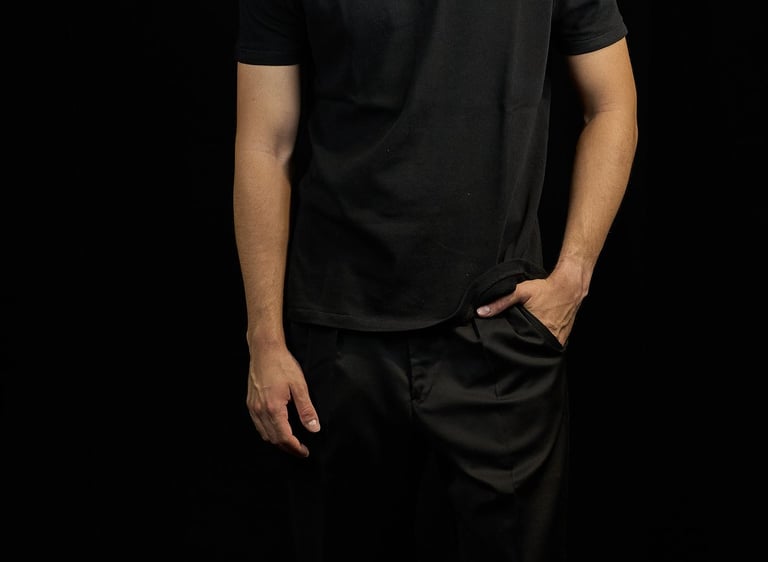 a man in a black shirt and white sneakers