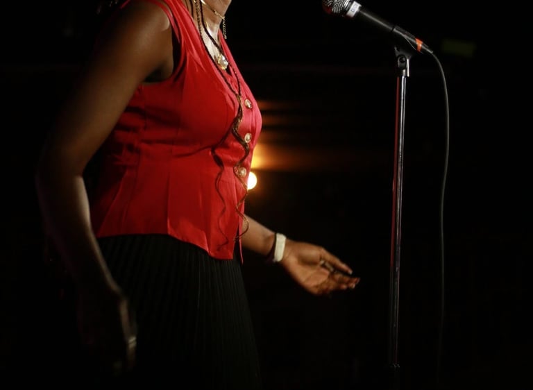 Iheoma Uzomba performing poetry at Calgary Poetry Slam