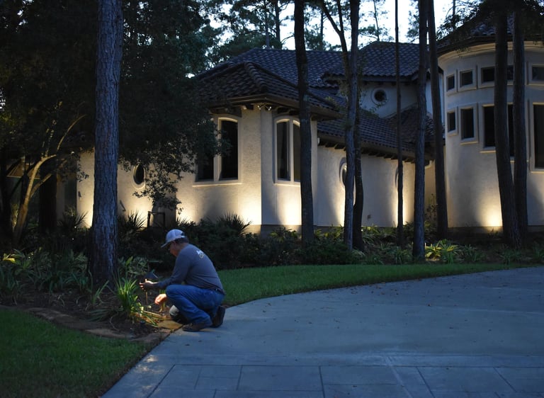 lighting technician servicing a path light fixture