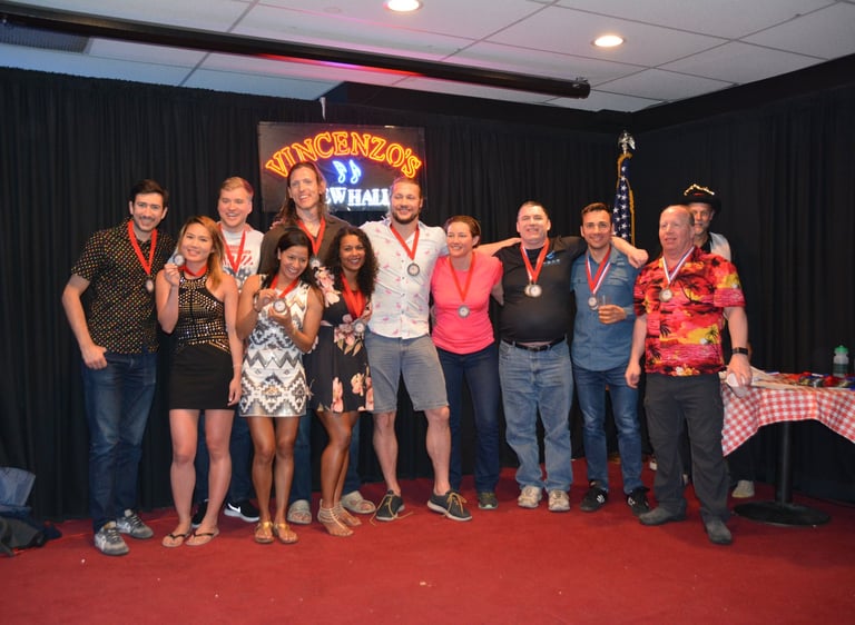 a group of people standing around a table with medals