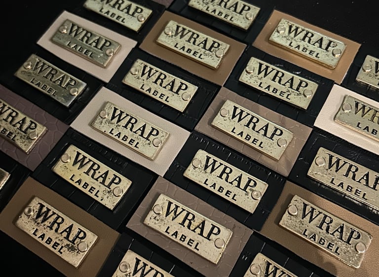 a bunch of leather and metallic labels that read "WRAP Label"