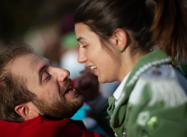 a man and woman are smiling and looking at each other