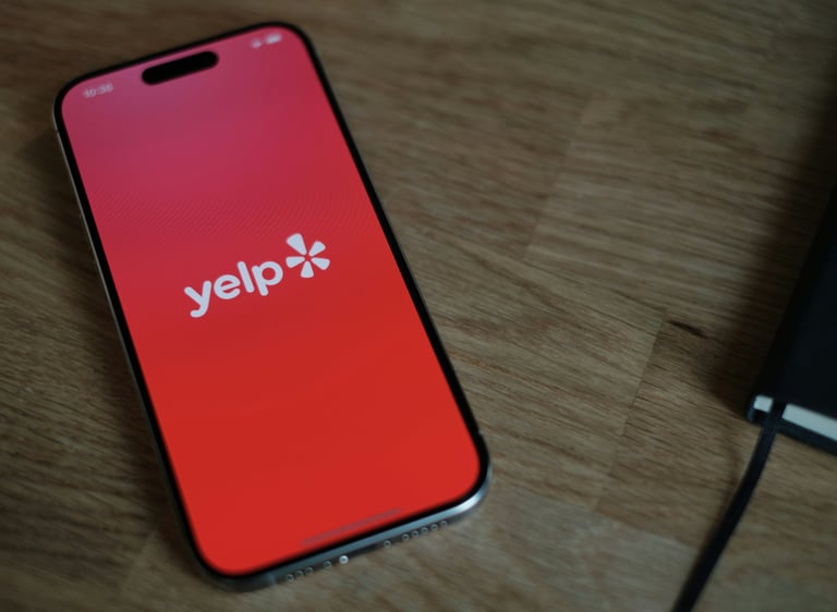 a picture of a cell phone with the Yelp app.