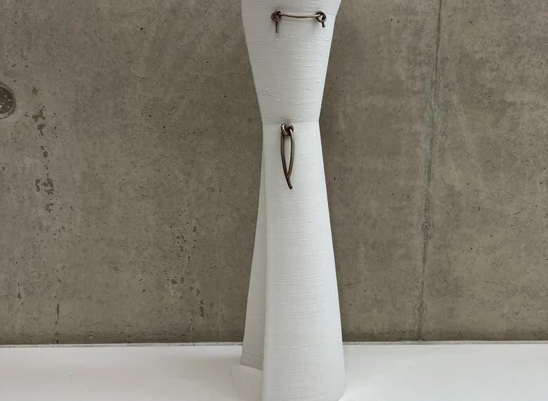 Tall & elegant ceramic vessel in 3d printed white porcelain, with bronze knot details