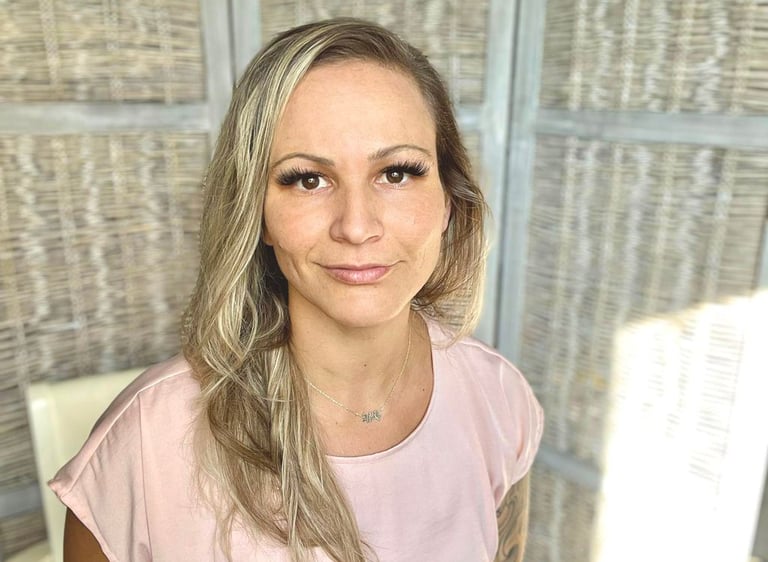 a woman with blonde hair and a pink shirt
