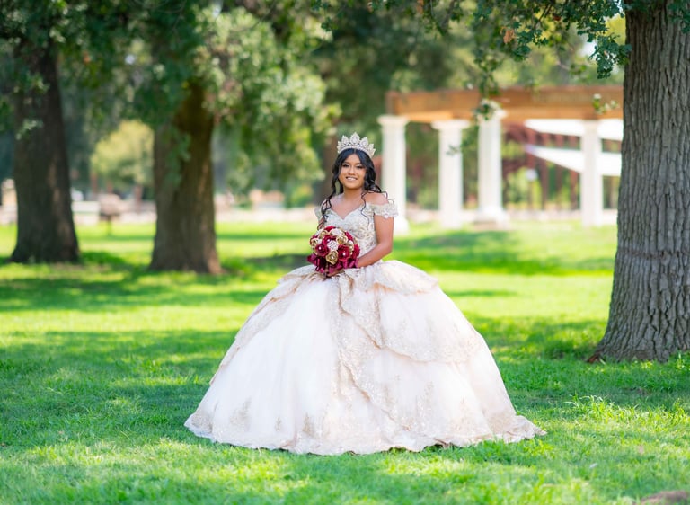 Professional Quinceañera photography in Visalia featuring a girl in a white and gold gown.
