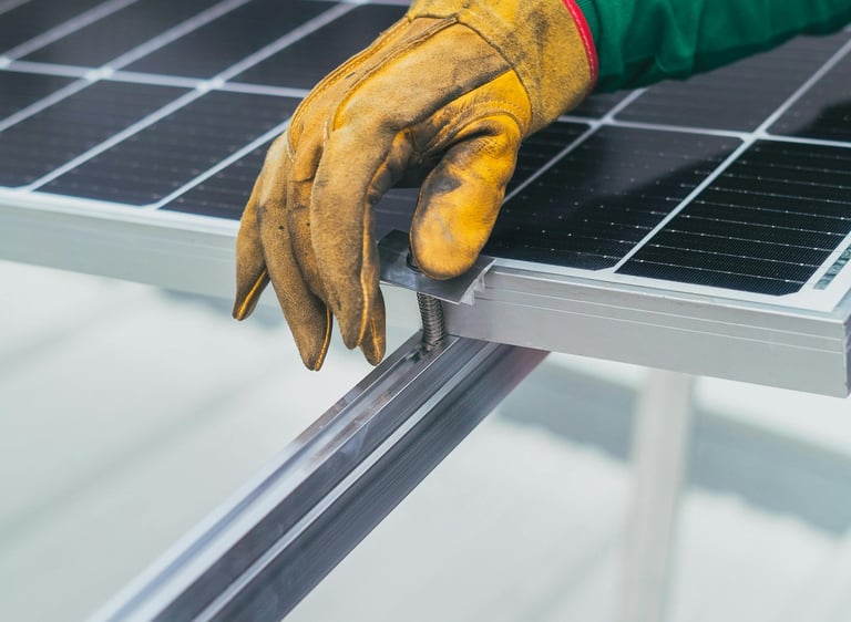 a person wearing gloves and gloves holding a solar panel