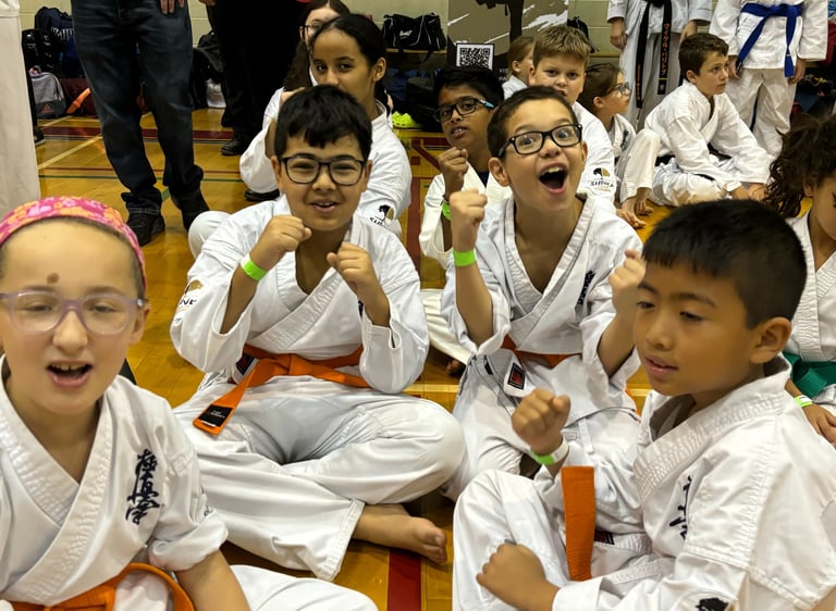a group of kids and adults in karate gear