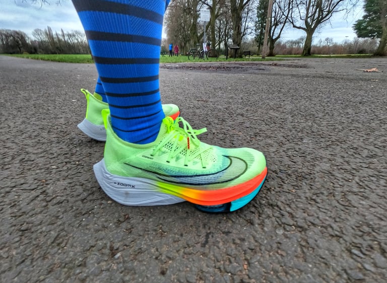 a person wearing a pair of Nike Alphafly trainers