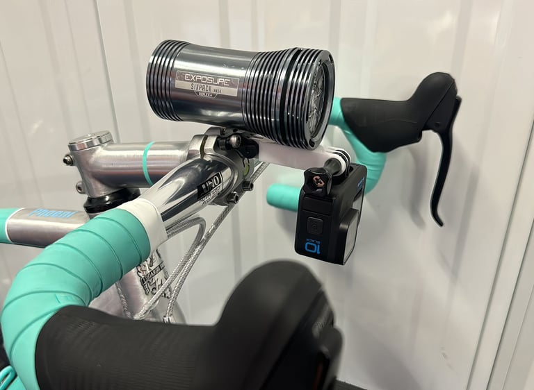 combo mount on a green bike with exposure light and Gopro camera installed