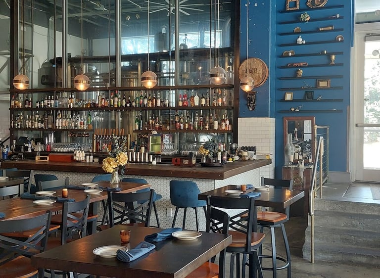 bar at flour & barrel with window behind showing brewing tanks